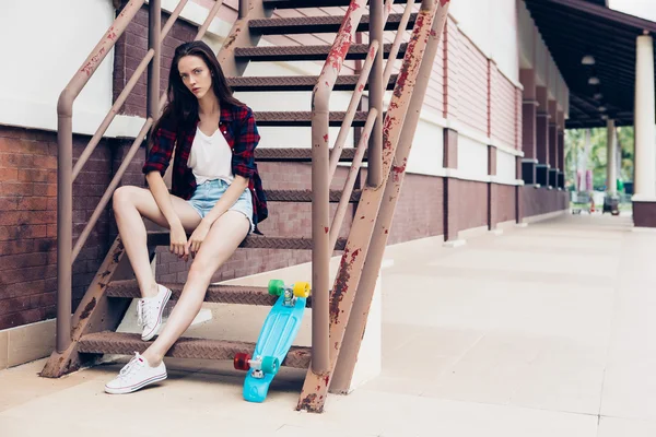 Hipster girl on metal stairs. — Stock Photo, Image