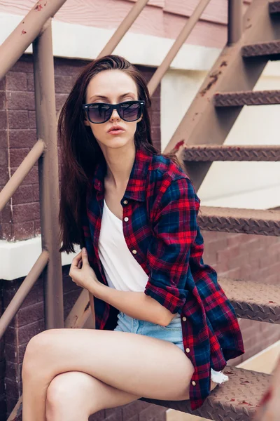Hipster girl on metal stairs. — Stock Photo, Image