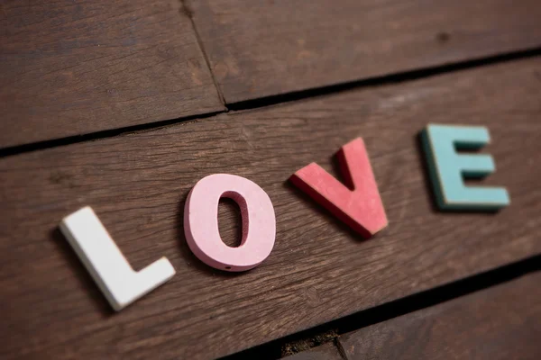 Word love on the wooden floor — Stock Photo, Image