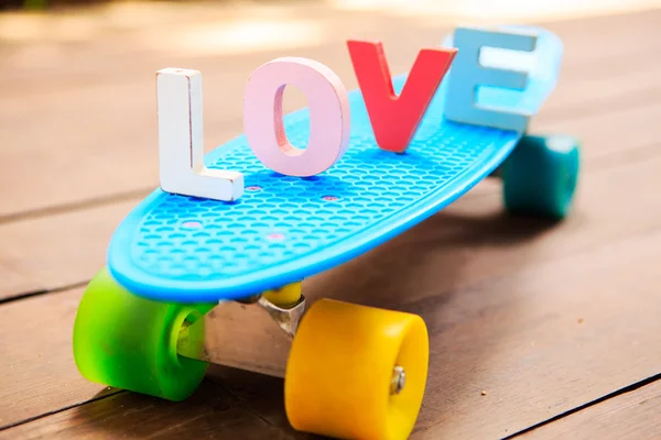 Word love on the blue penny board — Stock Photo, Image