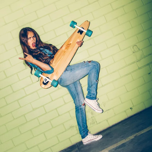 Lady play air guitar with skateboard — Stockfoto