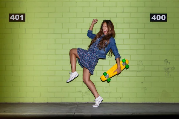 Hipster beautiful girl with skateboard — Stock Photo, Image