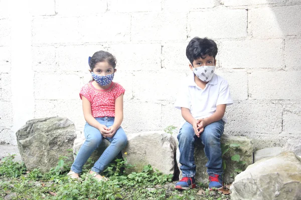 Year Old Latino Children Covid Face Masks Sitting White Wall — Stock Photo, Image