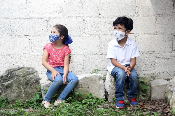 Year Old Latino Children Covid Face Masks Sitting White Wall — Stock Photo, Image