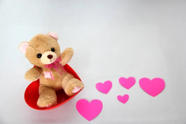 teddy bear and pink hearts on white background, valentine\'s day, advertising baner