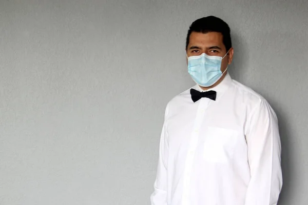 Latino waiter man with protective mask, works with latex gloves, new normal in restaurants. covid-19