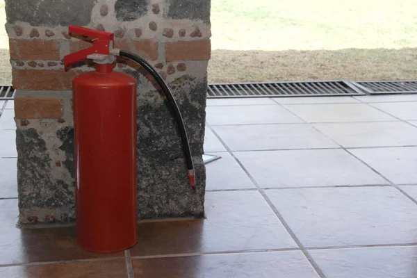 Red fire extinguisher to put out fires in the backyard of a house or business