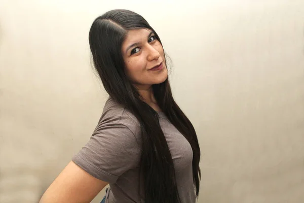 Latin woman with very long straight black hair happy showing her hair