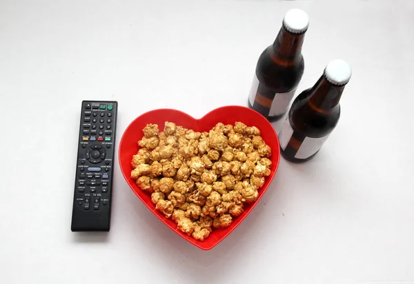 Caramelized popcorn ready to eat watching a movie on TV accompanied by drinks