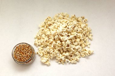 Natural popcorn with natural corn in a container or paper bag ready for a movie clipart