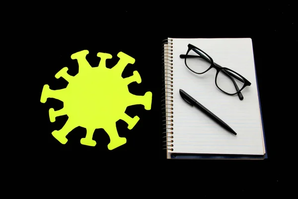 The Epidemiological Risk Traffic Light: yellow, for the use of public space according to the risk of contagion of COVID-19 with notebook, pen and glasses ready to go to school