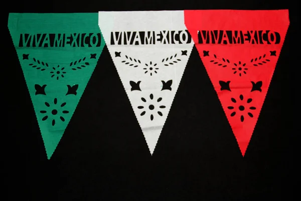 Decorative paper pennants for a Mexican party that say \