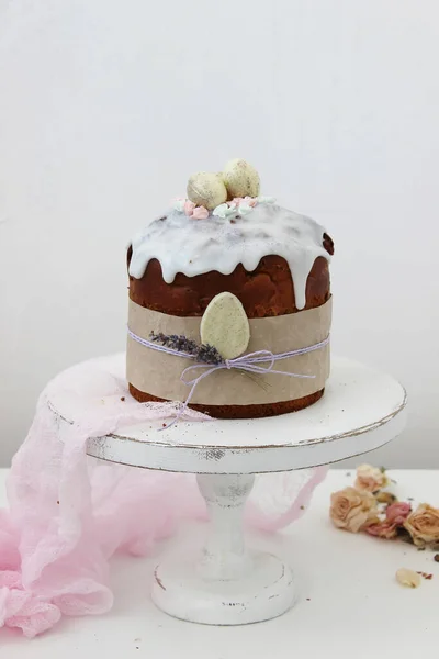Cake with a sprig of lavender and white chocolate eggs. Symbol of the traditional Russian Orthodox Easter. Close up.