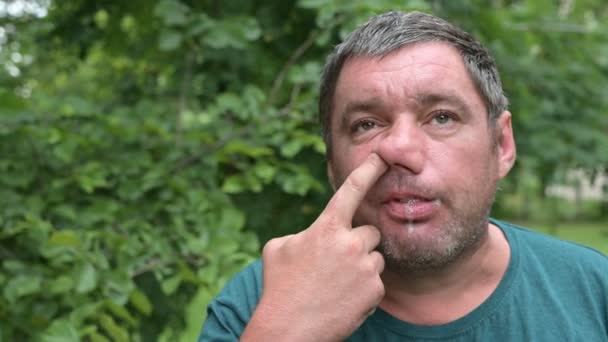 Mentally Retarded Toothless Unshaven Man Picks His Nose Drools Concept — Stock Video