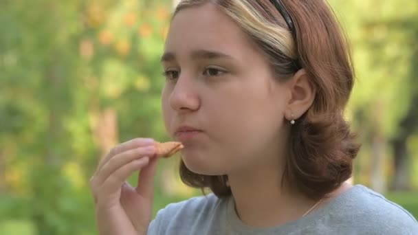 Uma Adolescente Com Cabelo Tingido Come Biscoitos Fundo Natureza Verde — Vídeo de Stock