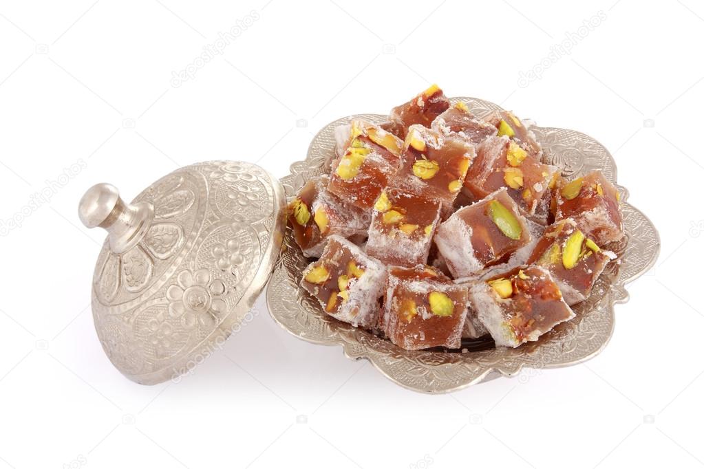 Turkish delights with pistachio nut in a metal sugar bowl isolat