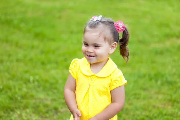 Photo of smiling little child girl in the park — Stock Photo, Image
