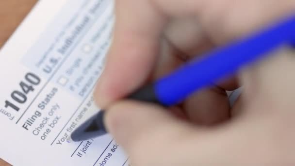 Man filling US 1040 tax form1040. Man is signing the 1040 tax form. — Stock Video