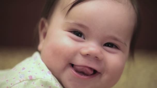 Little 5-month  baby girl is smiling. She is lying on the sofa. FullHD video — Stock Video