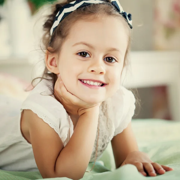 Girl is lying on the bed — Stock Photo, Image