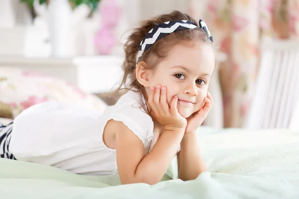 Girl is lying on the bed — Stock Photo, Image