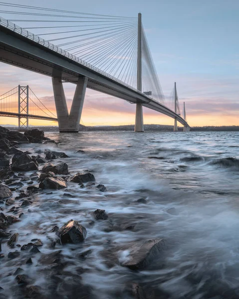 A view of a large three-tower cable-stayed bridge at sunrise — Stock Photo, Image