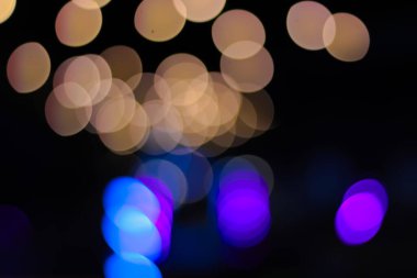 Abstract bokeh lights creating blurred circles of light over dark background for a festive feel, enhancing visual appeal, ideal for party invitations or greeting cards