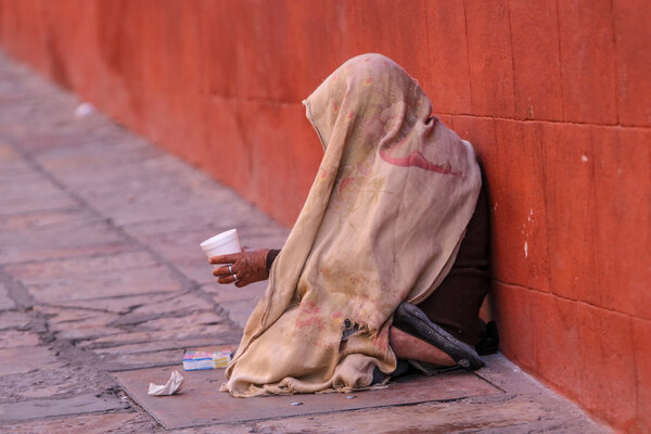 mexican street beggar woman with head covered 