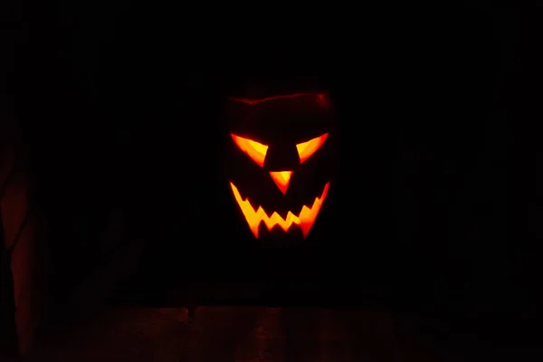 traditional glowing fiery Jack-o\'-lantern face from a pumpkin with candle on a halloween