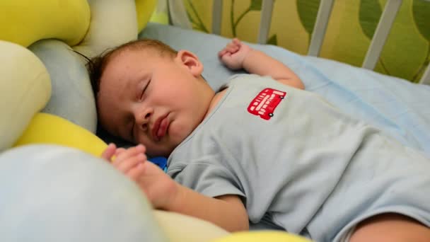 Frumos nou-născut copil copil mic băiat doarme în copilul său rău imitând buze suge — Videoclip de stoc