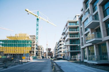 city development - construction site for building modern apartment blocks against housing shortage clipart