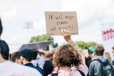 Amsterdam, Hollanda - 12 Eylül 2021: Amsterdam 'daki konut krizine karşı Woonprotest gösterisi, tabela takan kadın