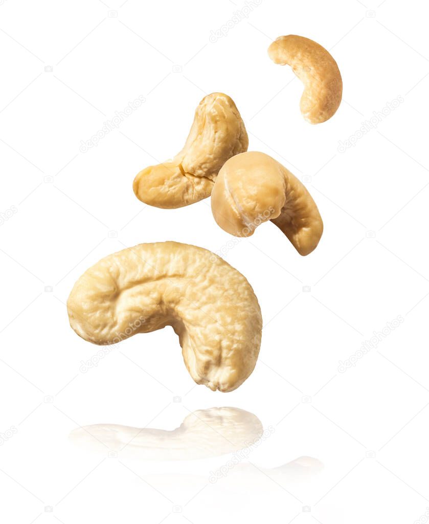 Fresh tasty Cashew nuts falling in the air isolated on white background. Food levitation concept. High resolution image.