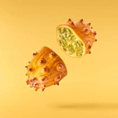 Taze taze kiwano izole bir şekilde havaya düşüyor. 
