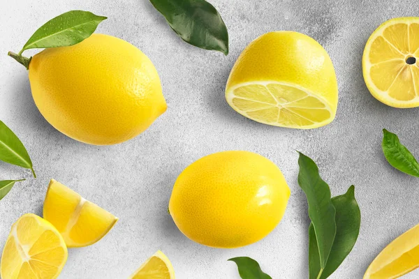 Creative Set Fresh Ripe Raw Lemons Green Leaves Concreate Background — Stock Photo, Image