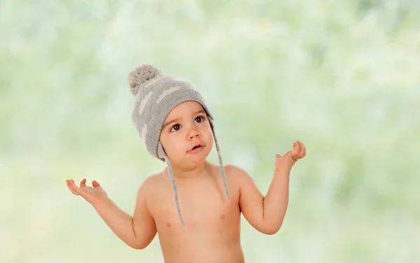 Adorable baby with wool cap asking something Royalty Free Stock Photos