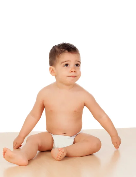 Adorable baby boy sitting on the floor — Stock Photo, Image