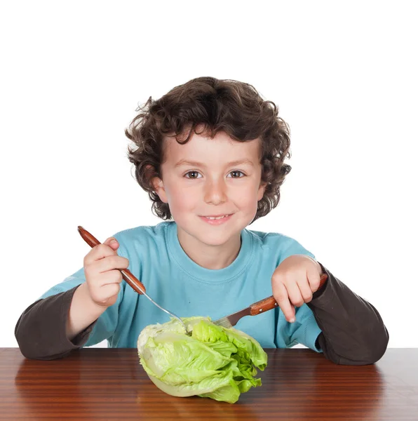 Little boy eating a lettuce — Stock Photo, Image