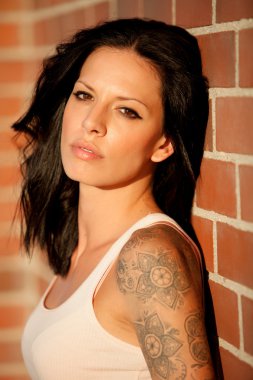 Kırmızı tuğla duvar arka plan ile güzel esmer