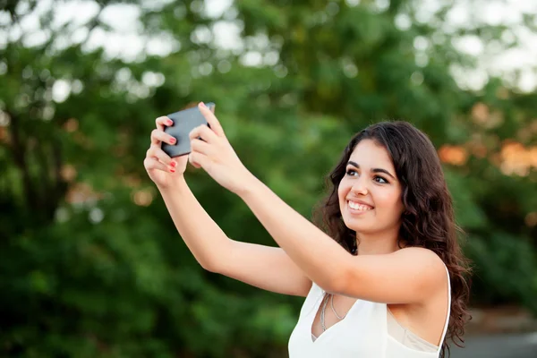 Brunette girl getting a photo with cellphone — Stock Photo, Image