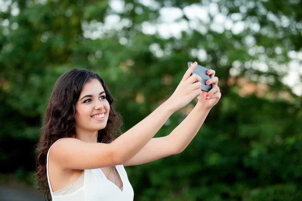 Brunette girl getting a photo with cellphone — Stock Photo, Image