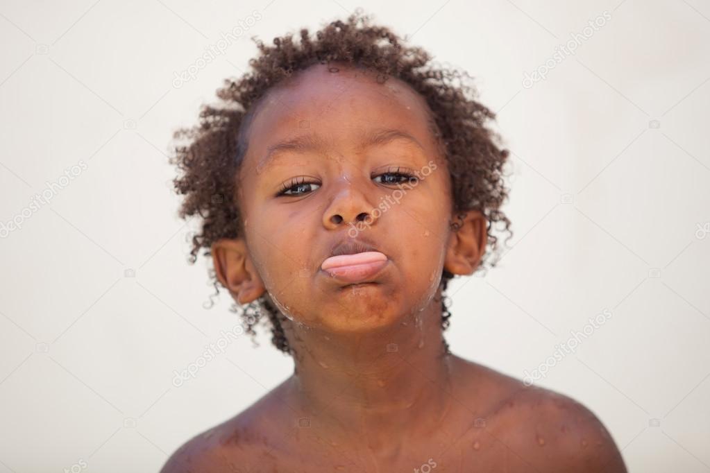 Funny african kid sticking his tongue out — Stock Photo © Gelpi 121200514