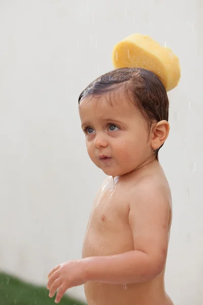 Funny kid showering in the yard — Stock Photo, Image