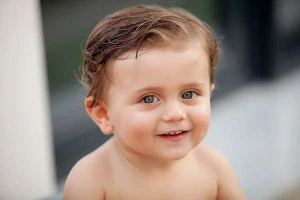 Beautiful baby outside with wet hair — Stock Photo, Image