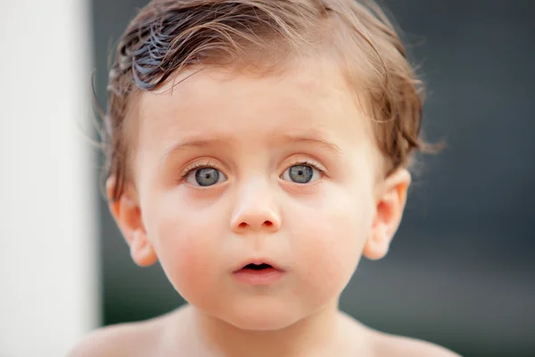 Beautiful baby outside with wet hair — Stock Photo, Image