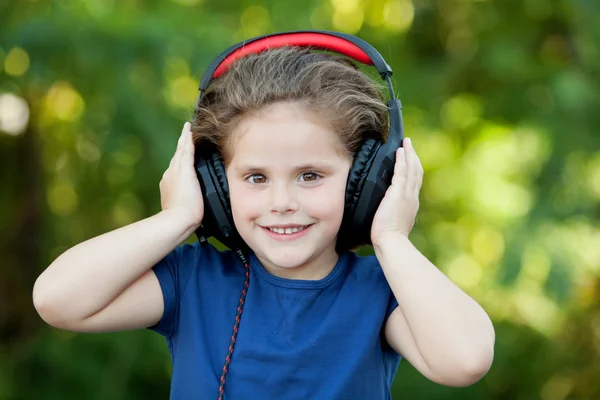Little girl with headphones outside — Stock Photo, Image