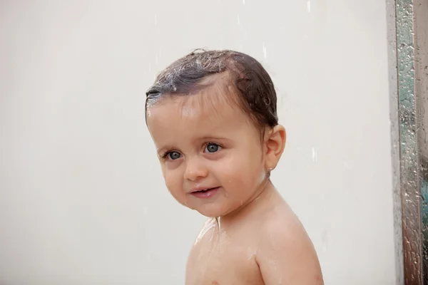 Funny baby showering in the pool — Stock Photo, Image