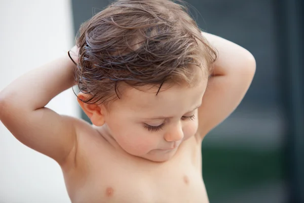 Beautiful baby outside with wet hair — Stock Photo, Image