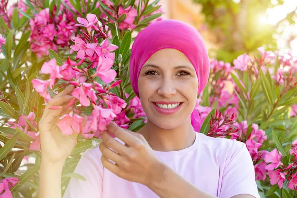 Woman with pink scarf on the head. Cancer awareness