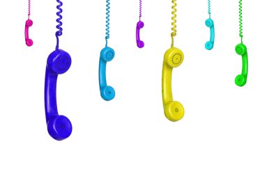 Beyaz arka planda izole edilmiş pek çok renkli eski telefon asılı.